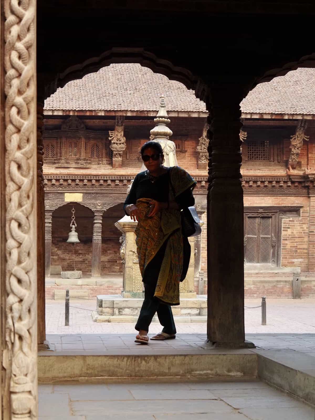 A woman in the courtyard of Patan Museum, once the palace of the Malla kings, Nepal.