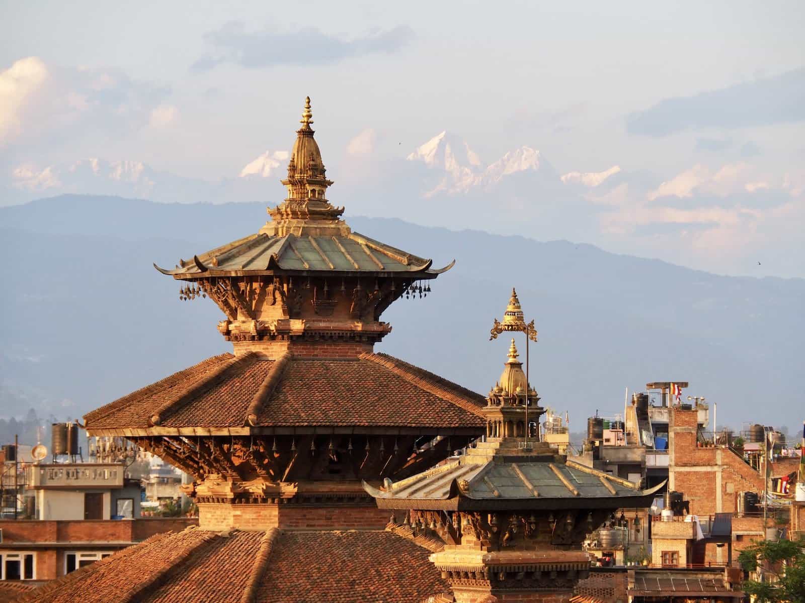 Majestic view of the Himalayas across the rooftops of Patan Durbar Sqaure, Nepal.