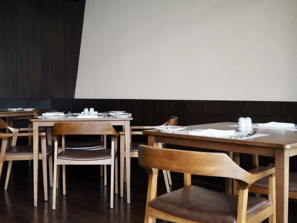 Sleek architectural lines and contemporary timber furniture in the restaurant of Kavya Resort, Nagarkot.