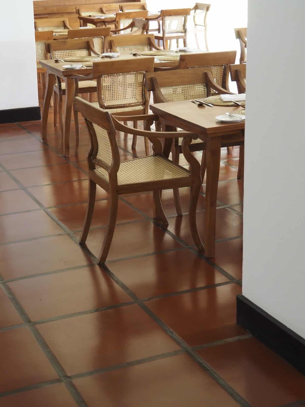 Square terracotta tiles and Anglo-Ceylonese chairs in the restaurant, Jetwing Lagoon Wellness.