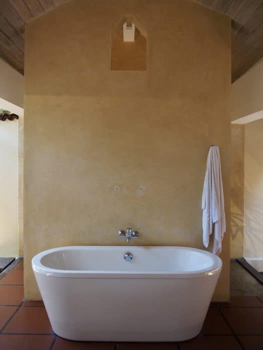 Indoor-outdoor bathroom with freestanding bathtub, Jetwing Lagoon Wellness.