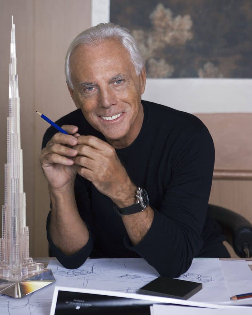 Giorgio Armani in his office with a model of the Burj Khalifa skyscraper, home to the Armani Hotel Dubai
