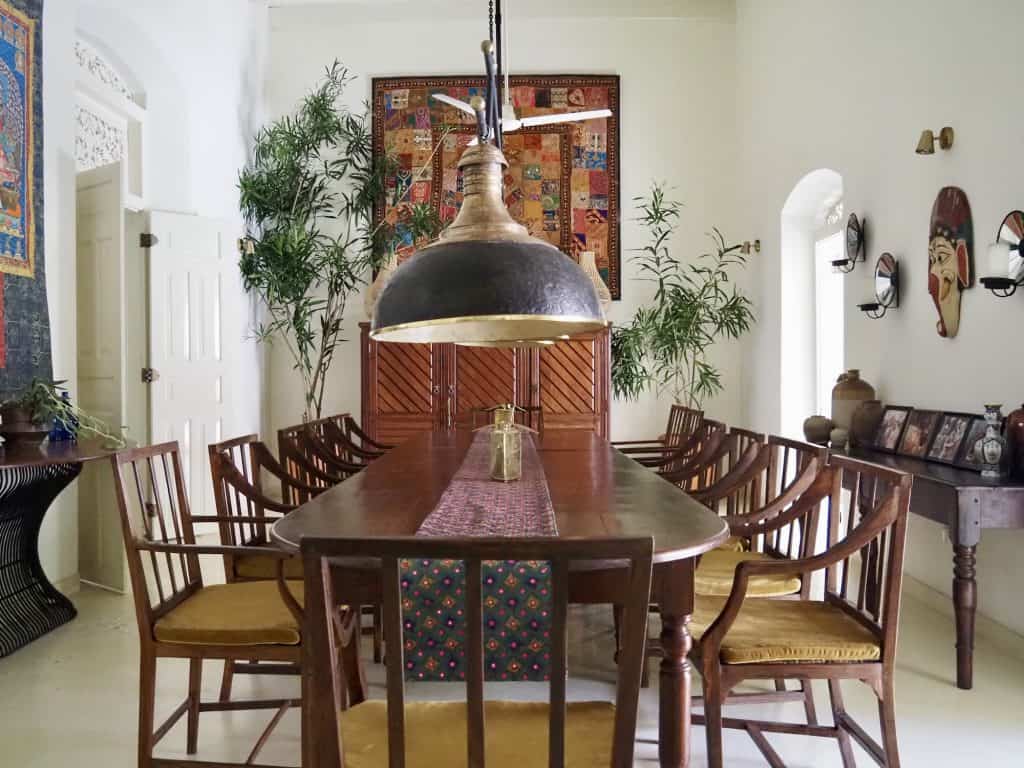 The dining room features a pendant light in papier-mâché, made by decorator Dick Dumas for The Sun House Galle, Sri Lanka.