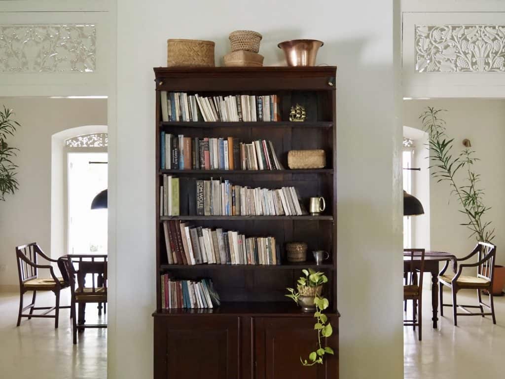 Books in the drawing room, The Sun House Galle, Sri Lanka.