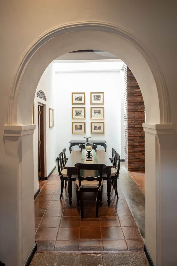writers-lodge-dining-room Dining room with white arch, vintage photos & original terracotta tiles, Writer's Lodge, Galle Fort.