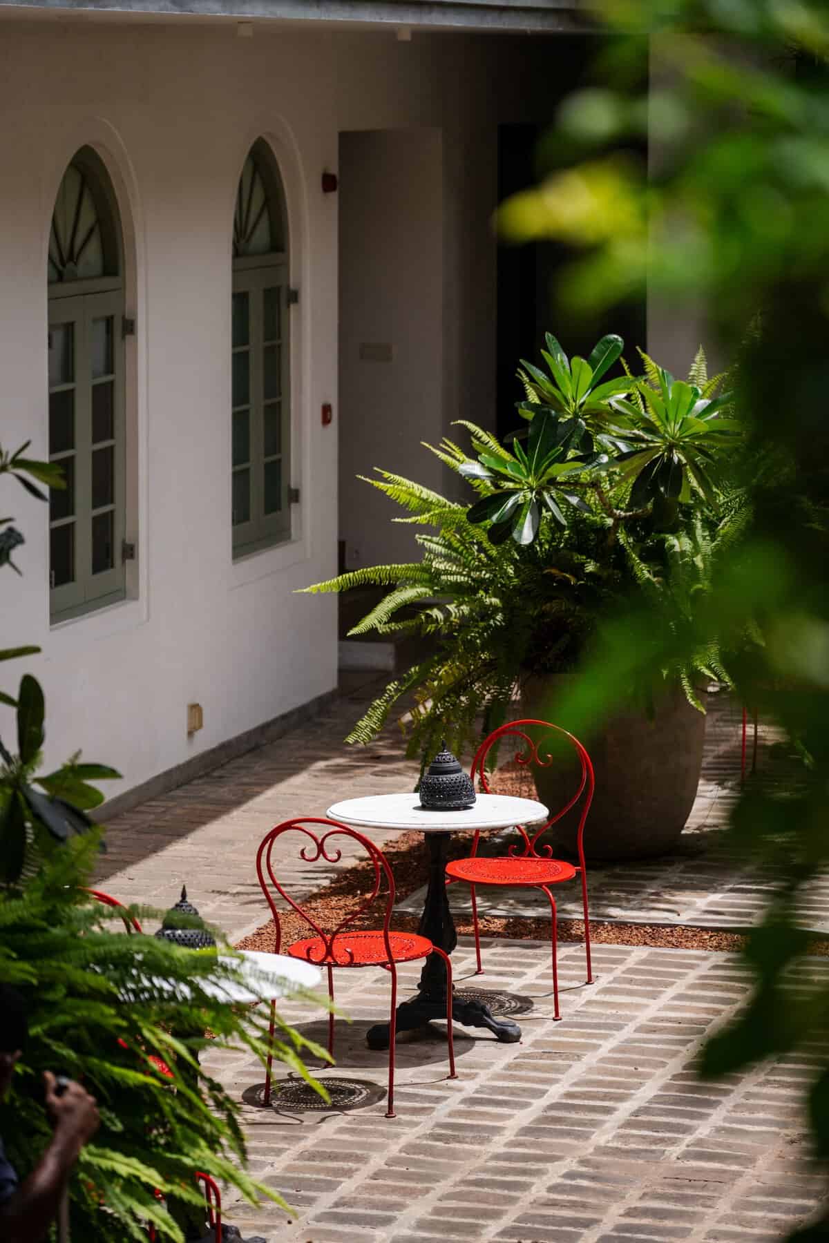 Red chairs in the courtyard of Fort Bazaar boutique hotel, Galle Fort, Sri Lanka.