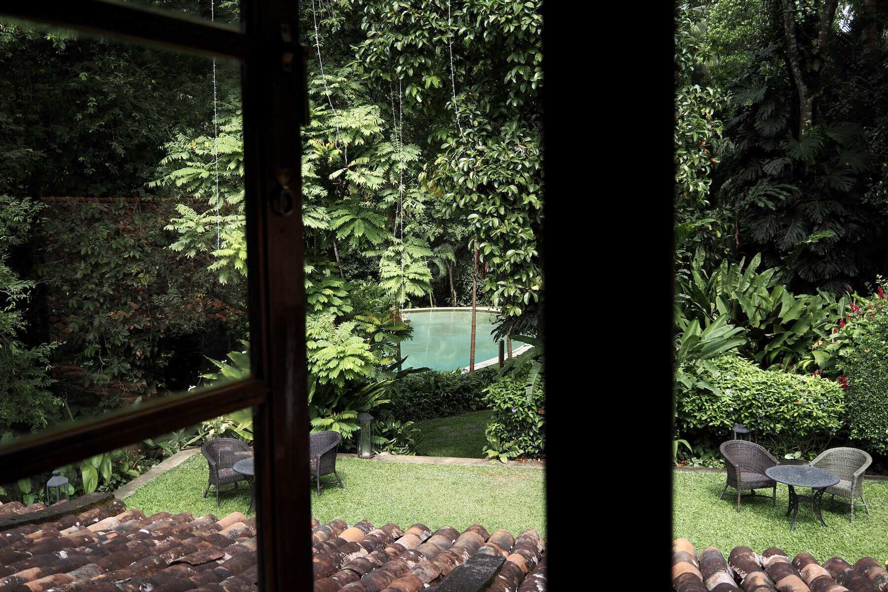 Adigar's Manor View of garden and swimming pool from the Indian Admiral suite, Adigar's Manor boutique hotel, Kandy, Sri Lanka.