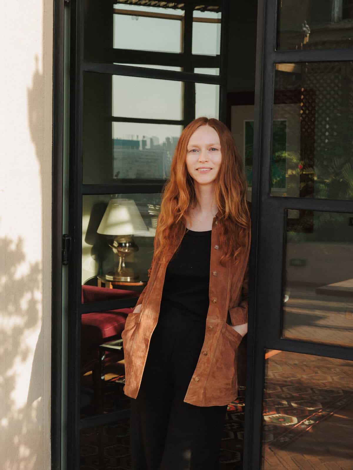 Philomena Schurer Merckoll in the doorway of an apartment in the Immobilia Building, Cairo.