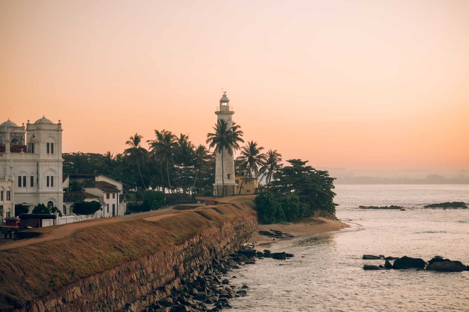 Galle lighthouse at sunset, overlooking the ramparts of UNESCO-listed Galle Fort.