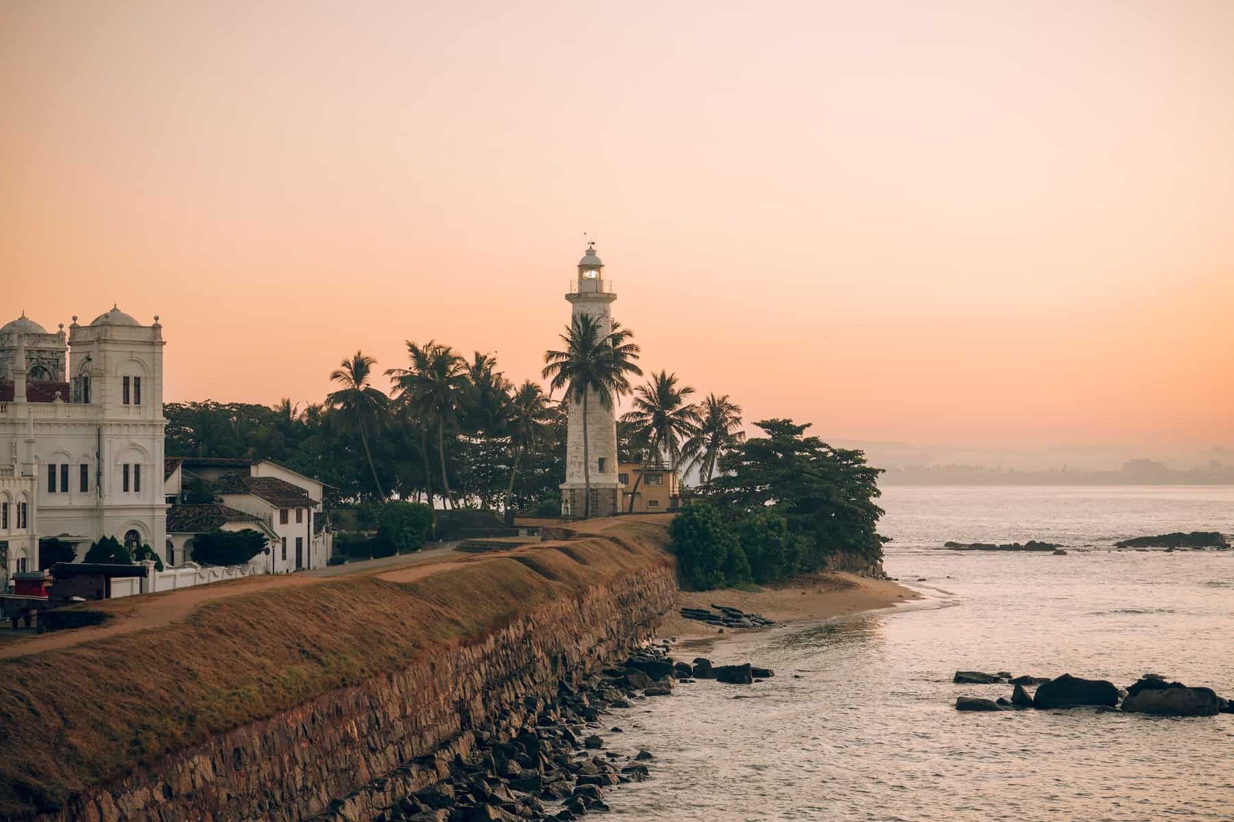Sri Lanka. the iconic Galle lighthouse at sunset, overlooking the ramparts of UNESCO-listed Galle Fort.