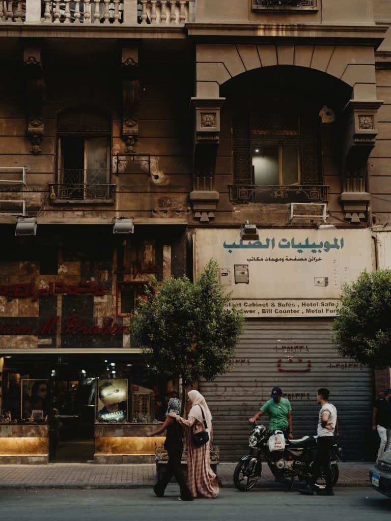 Street life, Belle Époque facades and soft afternoon light in Downtown Cairo.