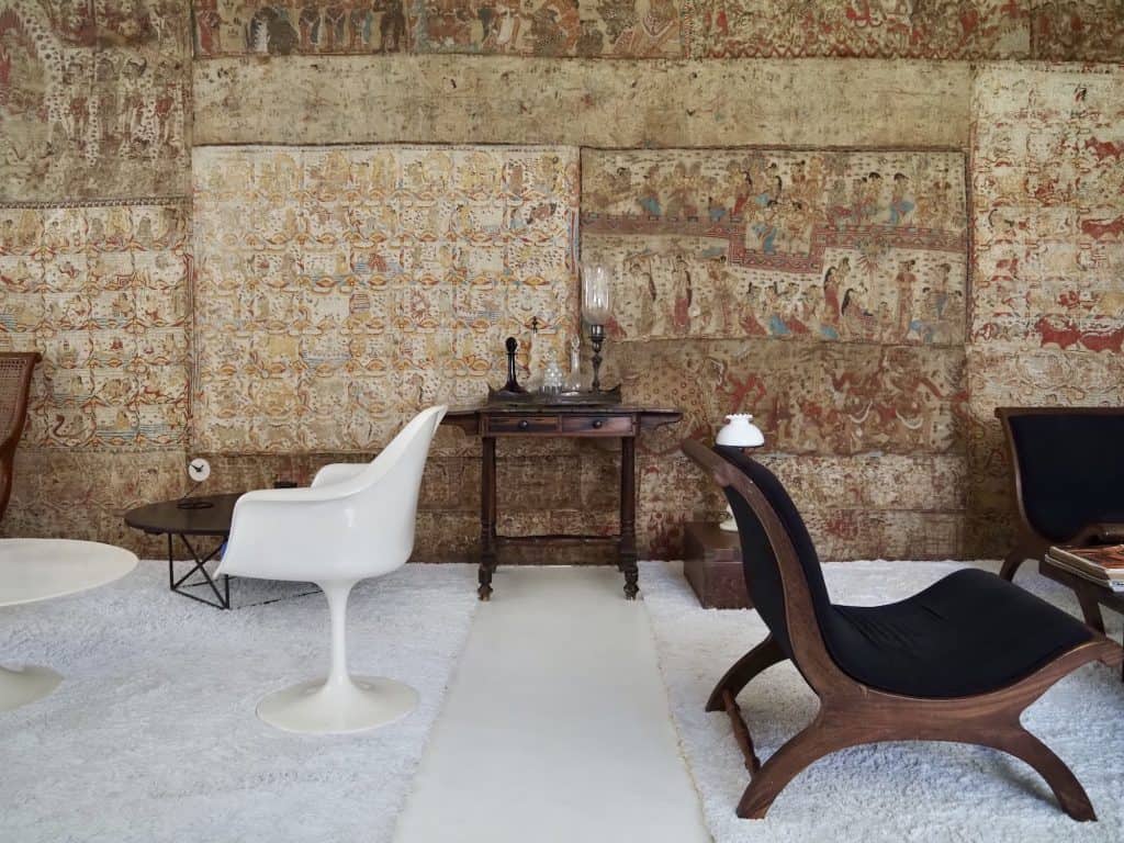 Geoffrey Bawa. Wall of batik, antique furniture and a modernist tulip chair at the Colombo home of Geoffrey Bawa, No.11.