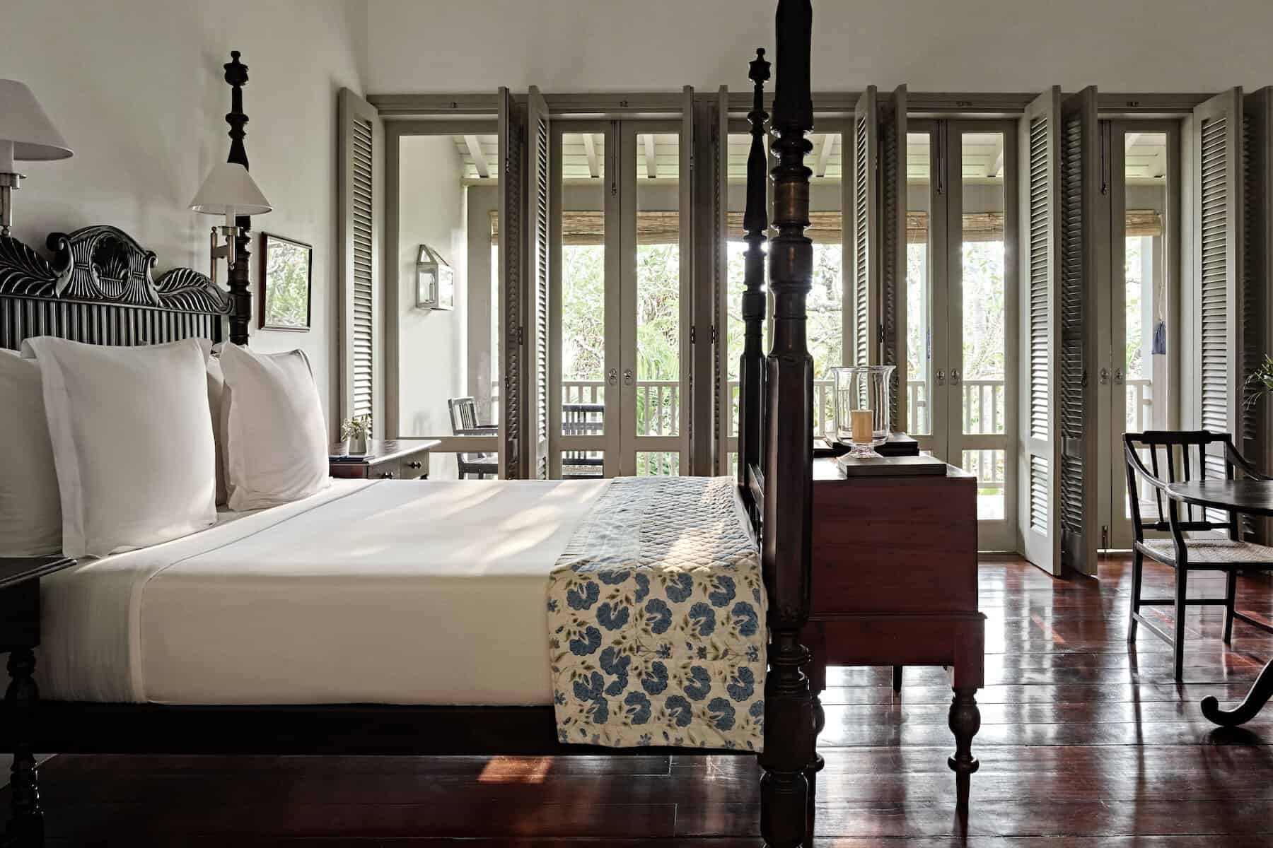 amangalla-bedroom-galle-fort Bedroom with antique four poster bed on a polished timber floor at Amangalla hotel, Galle Fort, Sri Lanka.