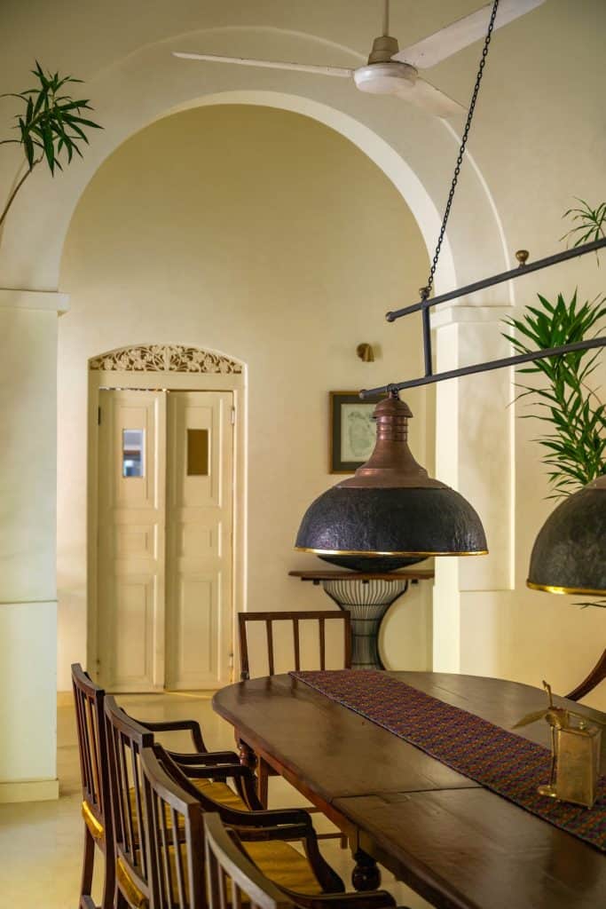 the-sun-house-dining-room Pendant light above long antique dining table The Sun House hotel, Galle.